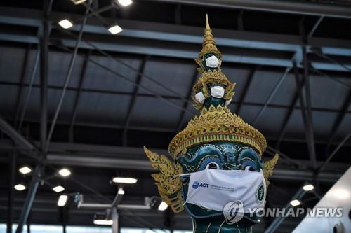 방콕 수완나품 공항 출국장의 마스크 쓴 동상