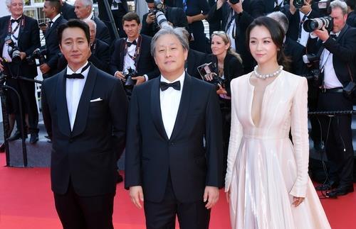 La foto, proporcionada por CJ ENM, muestra al director de cine surcoreano Park Chan-wook (centro), posando para una foto con la actriz china Tang Wei (dcha.) y el actor surcoreano Park Hae-il, protagonistas de la película "Decision to Leave". (Prohibida su reventa y archivo)