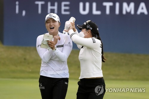In this Associated Press photo, Ko Jin-young of South Korea (L) is congratulated by a fellow player after winning the BMW Ladies Championship at LPGA International Busan in Busan, some 450 kilometers southeast of Seoul, on Oct. 24, 2021. (Yonhap)