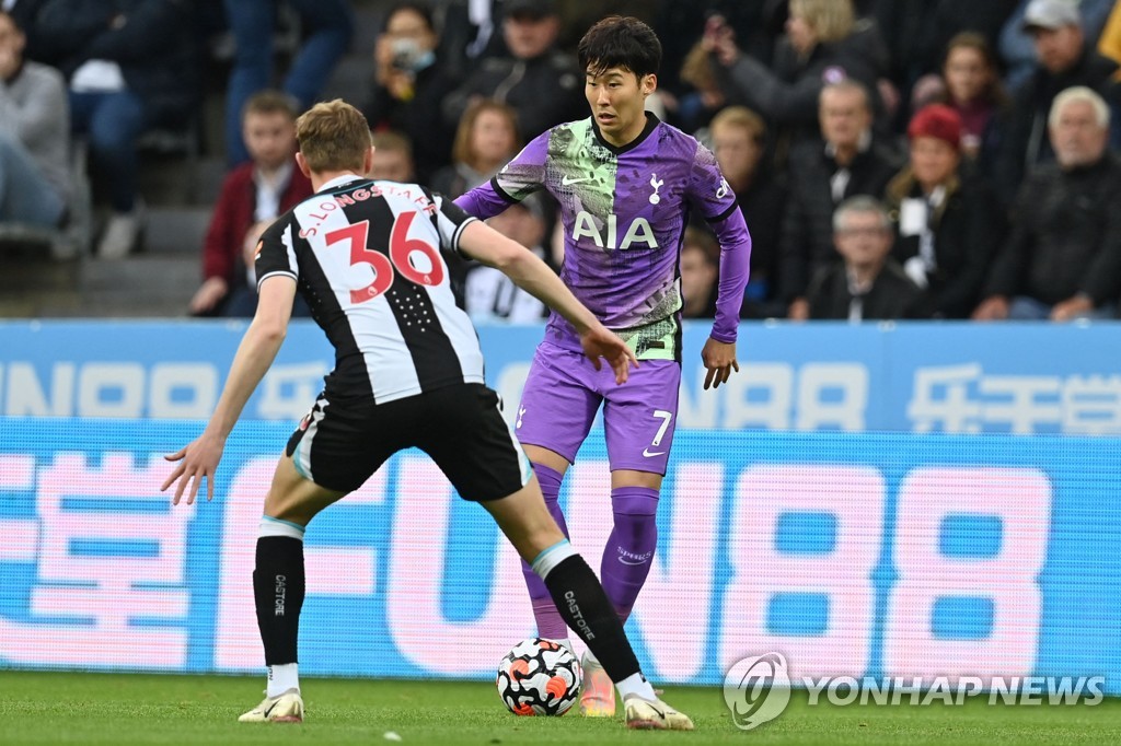 In this AFP photo, Son Heung-min of Tottenham Hotspur (R) tries to dribble past Sean Longstaff of Newcastle United during the clubs' Premier League match at St. James' Park in Newcastle, England, on Oct. 17, 2021. (Yonhap)
