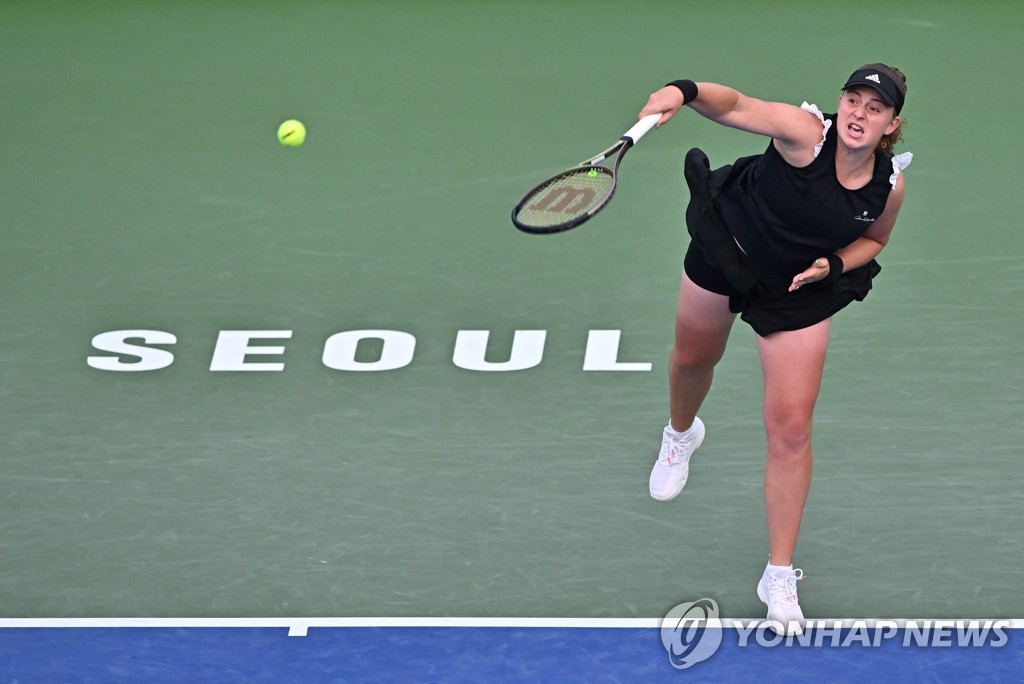 In this AFP photo, Jelena Ostapenko of Latvia serves to Anastasia Gasanova of Russia during their women's singles round of 16 match at the WTA Hana Bank Korea Open at Olympic Park Tennis Center in Seoul on Sept. 22, 2022. (Yonhap)