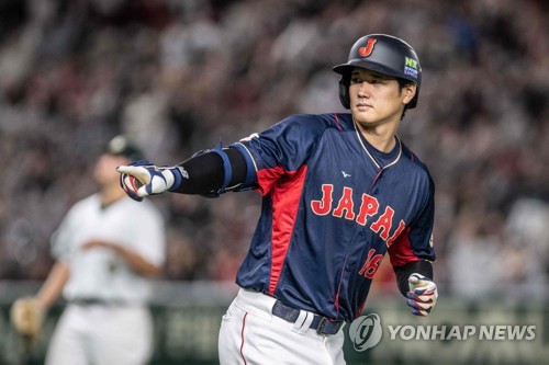 In this AFP photo, Shohei Ohtani of Japan celebrates his three-run home run against Australia during the top of the first inning of a Pool B game at the World Baseball Classic at Tokyo Dome in Tokyo on March 12, 2023. (Yonhap)