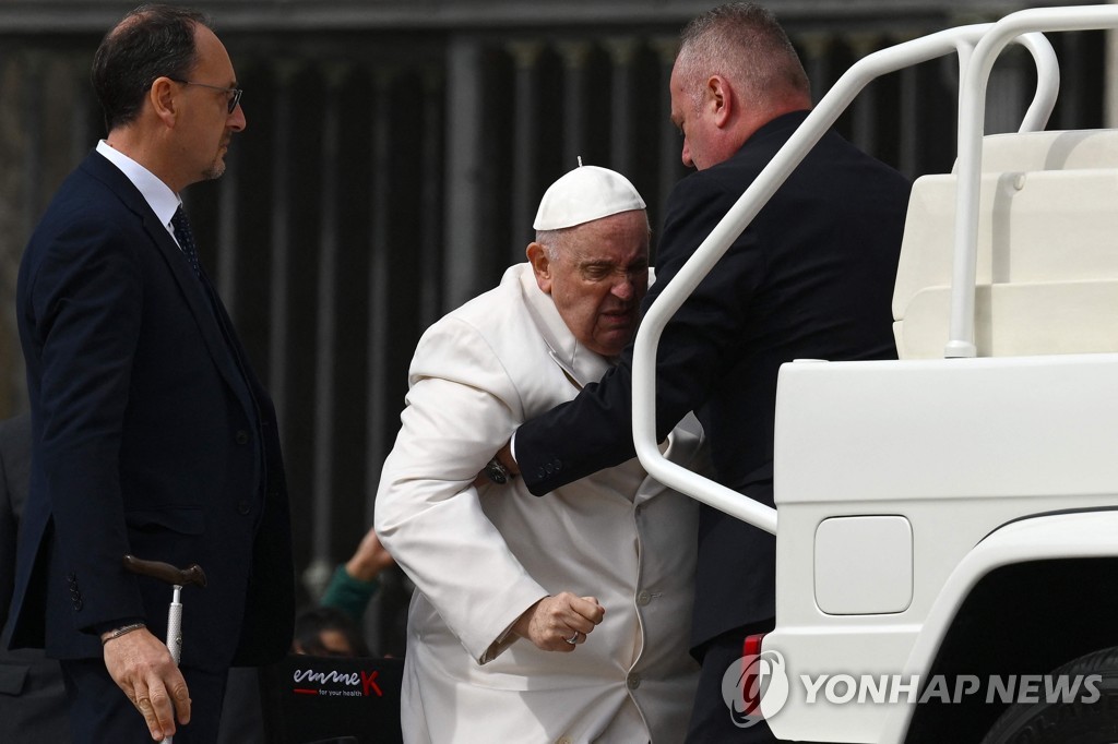 찡그린 채로 부축받으며 교황 전용차에 올라타는 프란치스코 교황