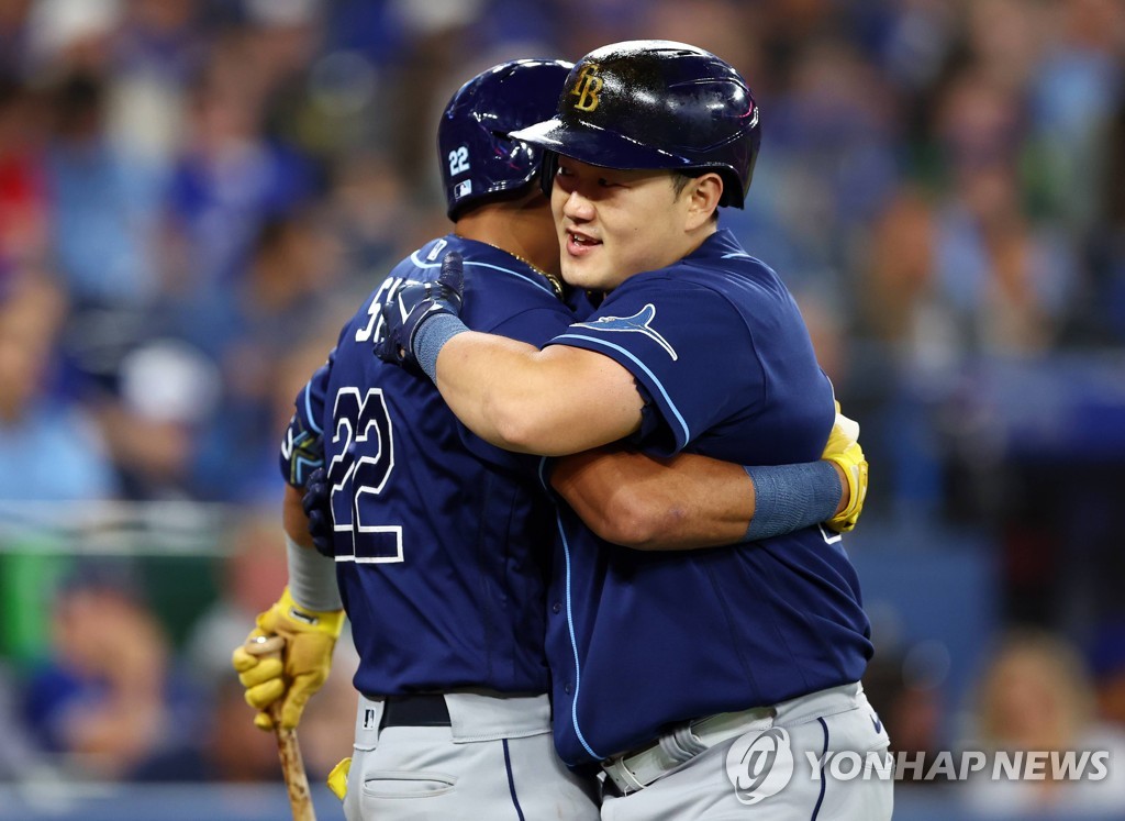 In this Getty Images photo, Choi Ji-man of the Tampa Bay Rays (R) embraces teammate Jose Siri after hitting a solo home run against the Toronto Blue Jays in the top of the third inning of a Major League Baseball regular season game at Rogers Centre in Toronto on Sept. 13, 2022. (Yonhap)