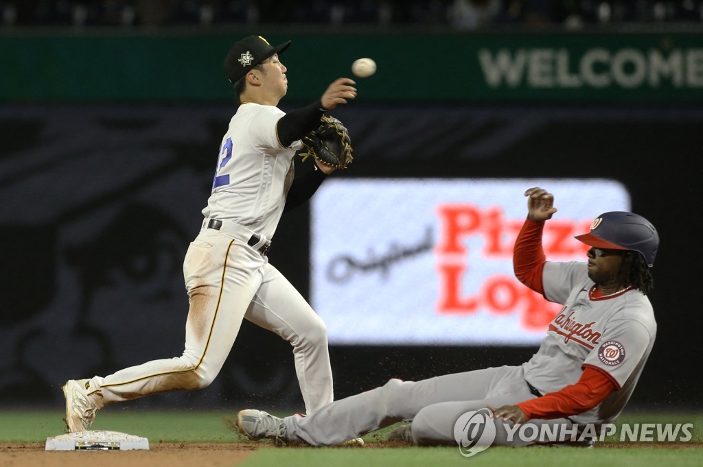 In this USA Today Sports photo via Reuters, Pittsburgh Pirates' shortstop Park Hoy-jun (L) turns a double play over Josh Bell of the Washington Nationals during the top of the sixth inning a Major League Baseball regular season game at PNC Park in Pittsburgh on April 15, 2022. (Yonhap) 