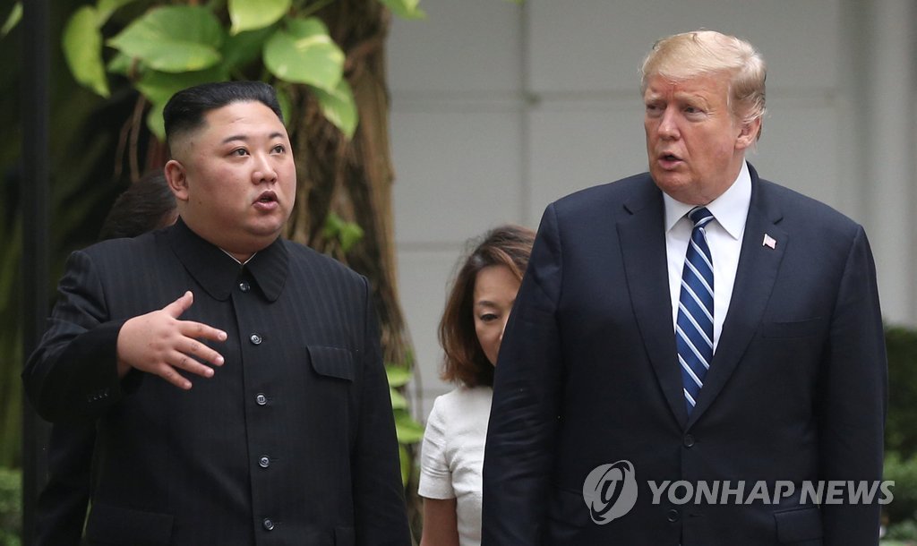 This AP photo shows North Korean leader Kim Jong-un (L) and U.S. President Donald Trump walking in a garden at the Sofitel Legend Metropole Hanoi hotel on Feb. 28, 2019. (Yonhap)