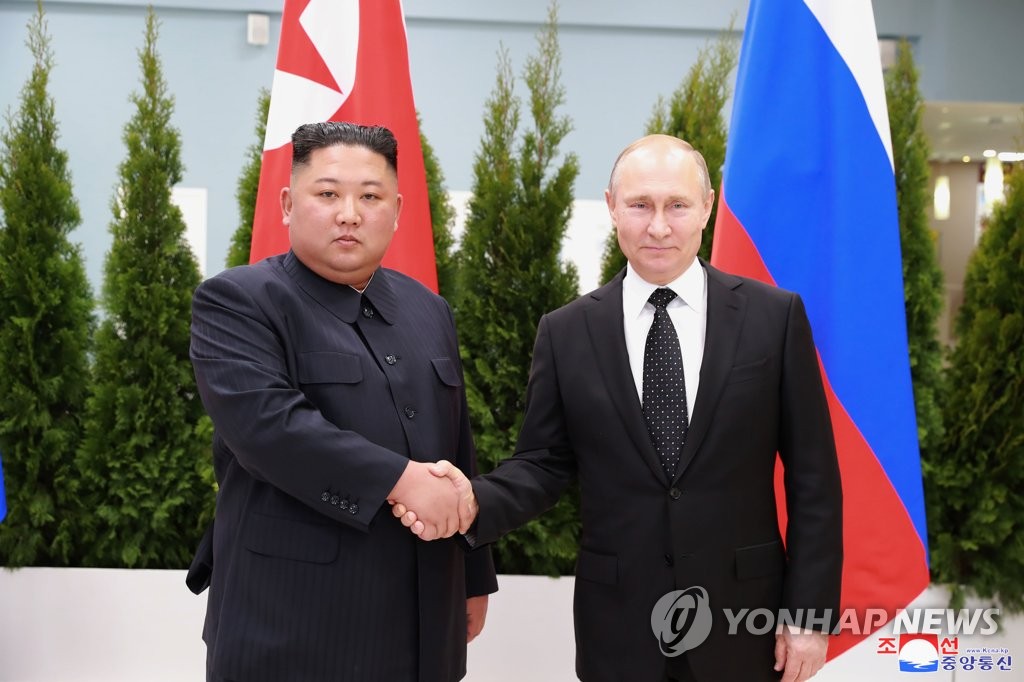 This file photo, carried by North Korea's official Korean Central News Agency, shows North Korean leader Kim Jong-un (L) and Russian President Vladimir Putin shaking hands for a summit in Vladivostok on April 26, 2019. (For Use Only in the Republic of Korea. No Redistribution) (Yonhap)