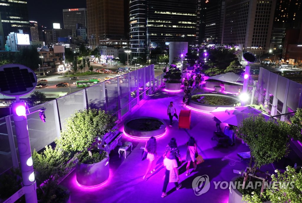 Landmarks in Seoul illuminated in violet to celebrate BTS