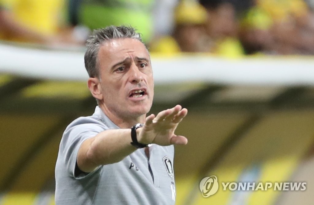 In this file photo from Nov. 19, 2019, Paulo Bento, head coach of the South Korean men's national football team, directs his players during a friendly match against Brazil at Mohammed Bin Zayed Stadium in Abu Dhabi. (Yonhap)