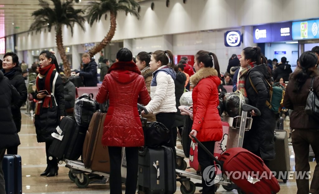 This photo, taken on Dec. 21, 2019, shows women presumed to be North Korean workers at the arrival hall of Beijing international airport, one day ahead of the U.N.-imposed deadline for member states to repatriate all North Korean laborers home. (Yonhap)