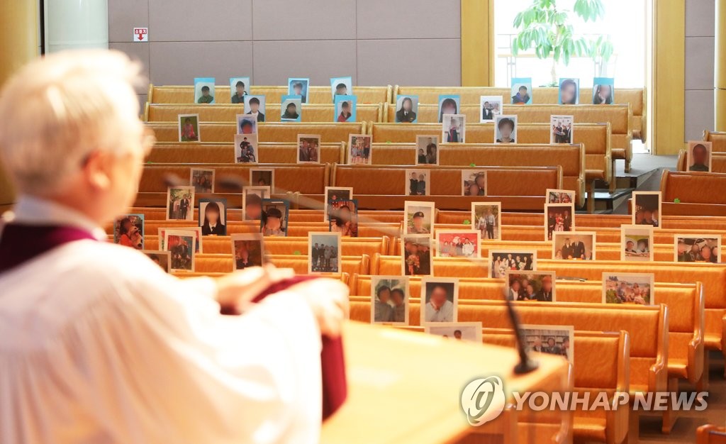 This photo, taken on April 12, 2020, shows a pastor holding an online Easter service, with photos of believers on chairs, at a church in Seongnam, Gyeonggi Province. (Yonhap)