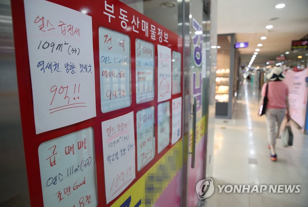 This photo, taken on June 14, 2020, shows signs with bidding prices for housing transactions put up at a real estate agency in Seoul. (Yonhap)