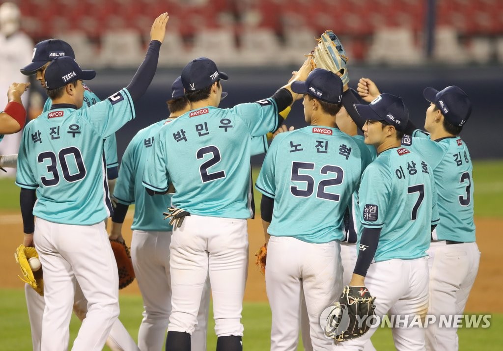 In this file photo from June 26, 2020, members of the NC Dinos celebrate their 9-3 victory over the Doosan Bears in a Korea Baseball Organization regular season game at Jamsil Baseball Stadium in Seoul. (Yonhap)