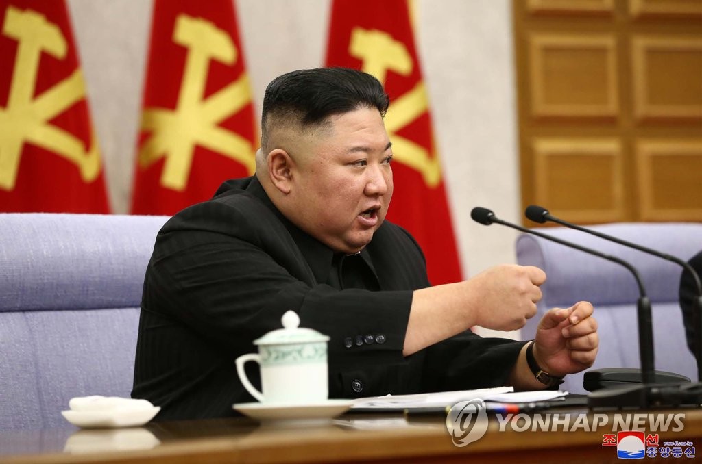 North Korean leader Kim Jong-un clenches his fist during a meeting of the central committee of the Workers' Party in Pyongyang on Feb. 8, 2021, in this photo released by the Korean Central News Agency. (For Use Only in the Republic of Korea. No Redistribution) (Yonhap)