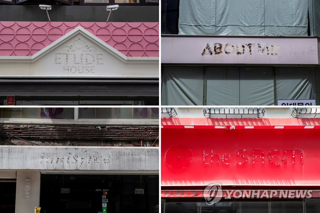 The storefronts of old cosmetic shops with removed signs in Myeongdong, the main shopping district in downtown Seoul, are seen in this photo taken July 14, 2021. (Yonhap)