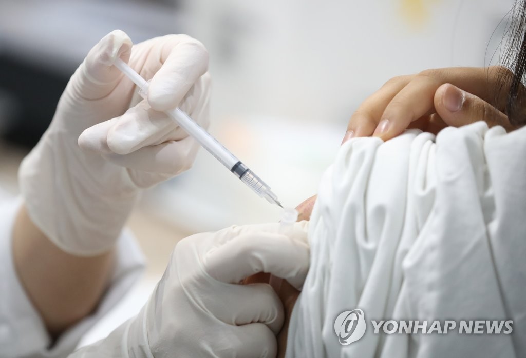 This photo, taken Sept. 7, 2021, shows a health worker giving a COVID-19 vaccine shot at an inoculation center in western Seoul. (Yonhap)