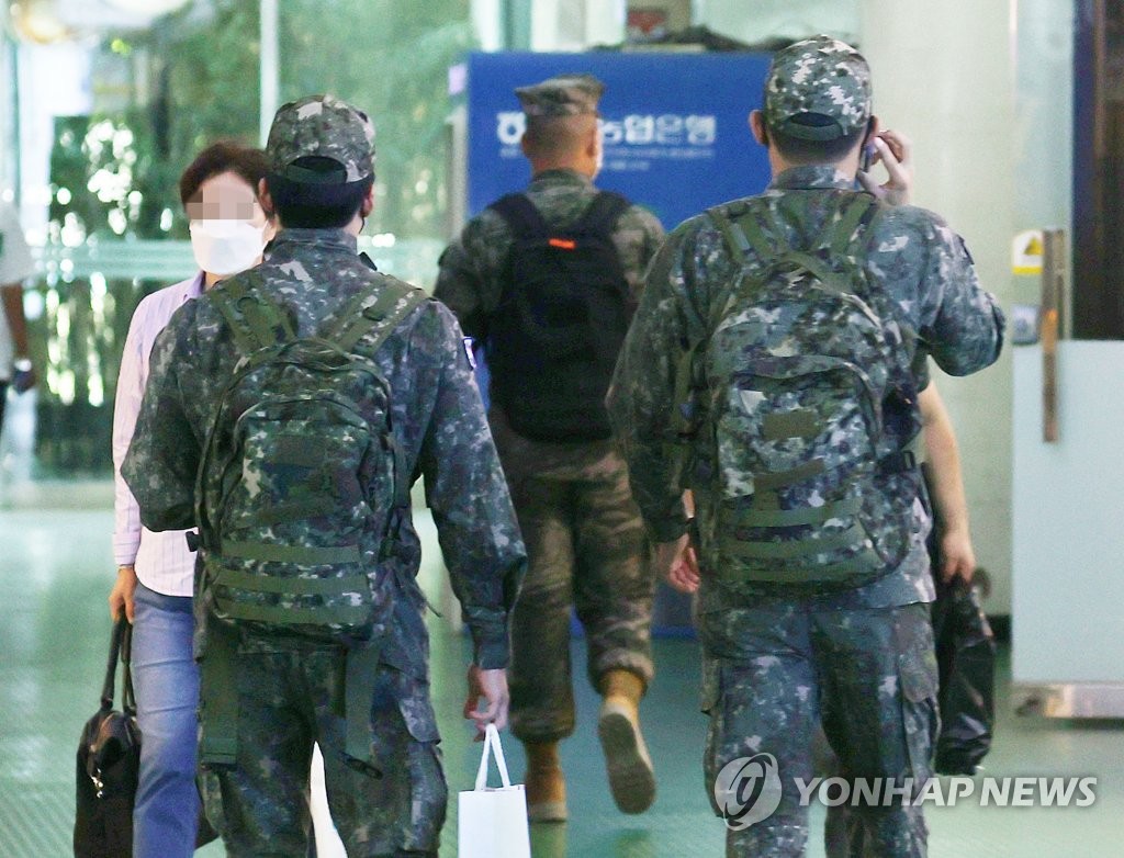 In this file photo taken Oct. 3, 2021, soldiers walk at a bus terminal in eastern Seoul. (Yonhap)