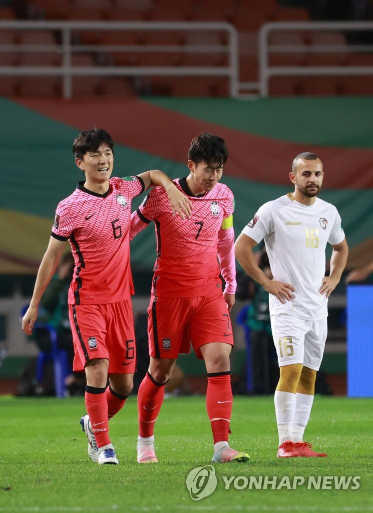 Hwang In-beom of South Korea (L) is congratulated by teammate Son Heung-min after scoring a goal against Syria during the teams' Group A match in the final Asian qualifying round for the 2022 FIFA World Cup at Ansan Wa Stadium in Ansan, Gyeonggi Province, on Oct. 7, 2021. (Yonhap)
