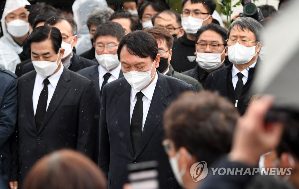 Yoon Seok-youl (C), the presidential nominee of the People Power Party, offers a silent tribute to victims of the 1980 Gwangju pro-democracy uprising at the May 18th National Cemetery in the city on Nov. 10, 2021. (Pool photo) (Yonhap)
