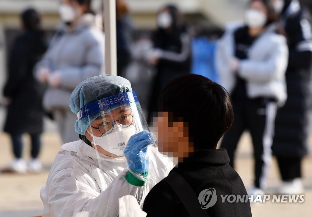 A student gets tested for COVID-19 at a high school in the southwestern city of Gwangju, South Korea, on Dec. 3, 2021. (Yonhap)