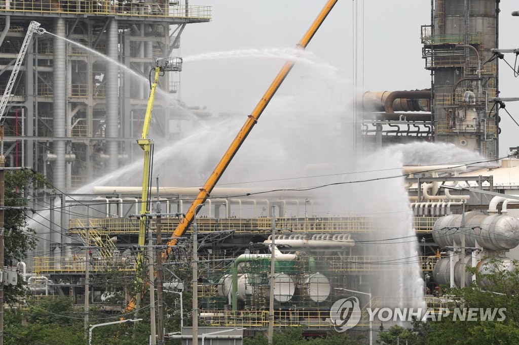 Firefighters work to put out a fire at a refinery run by S-Oil Corp. in the southeastern industrial city of Ulsan, about 415 kilometers southwest of Seoul, on May 20, 2022, a day after the explosion that killed one and injured nine others. (Yonhap)