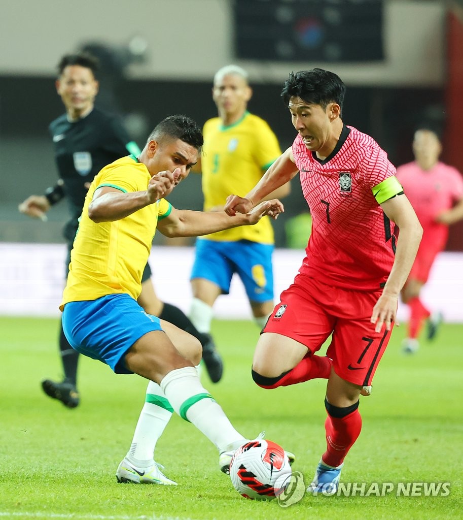 Son Heung-min of South Korea (R) tries to dribble past Casemiro of Brazil during the countries' friendly football match at Seoul World Cup Stadium in Seoul on June 2, 2022. (Yonhap)