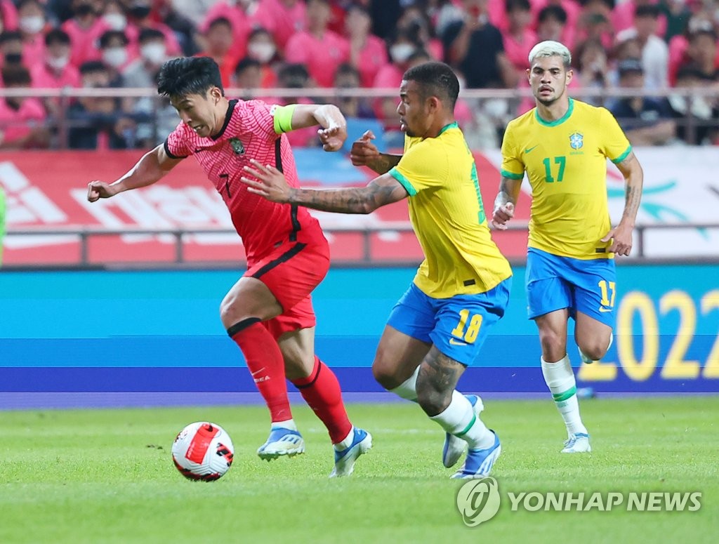 Son Heung-min of South Korea (L) tries to sprint past Gabriel Jesus of Brazil during their teams' football friendly match at Seoul World Cup Stadium in Seoul on June 2, 2022. (Yonhap)