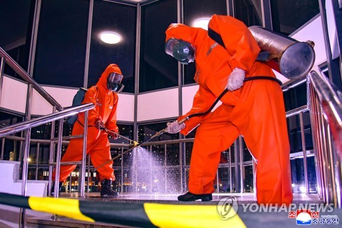 This photo, carried by North Korea's official Korean Central News Agency on June 7, 2022, shows quarantine officials carrying out disinfection work. (For Use Only in the Republic of Korea. No Redistribution) (Yonhap)