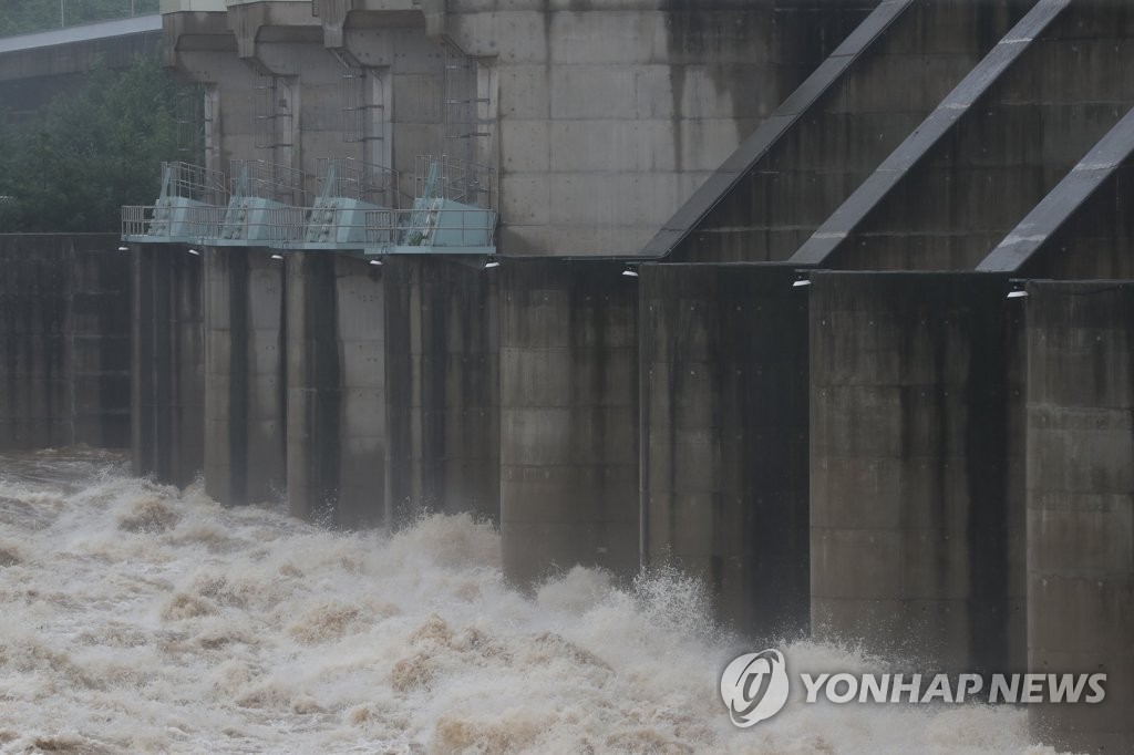 Water gushes out of the floodgates of the Gunnam Dam on the Imjin River that runs across the inter-Korean border in the South Korean border town of Yeoncheon, north of Seoul, on June 29, 2022, as the state-run Korea Water Resources Corp. opened the dam's floodgates to lower the water level following heavy rain in North Korea. The dam, built in 2010, was designed to deal with flash floods from North Korea. (Yonhap)