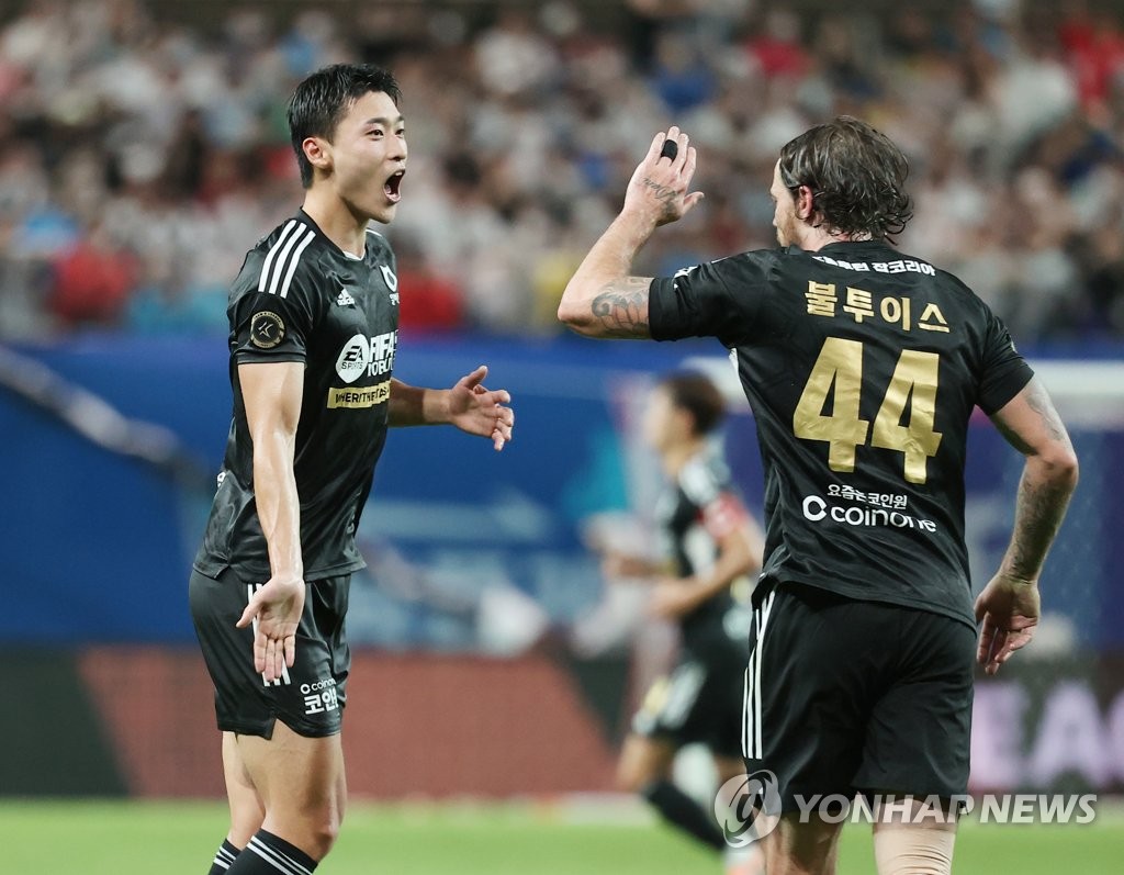 Cho Gue-sung of Team K League (L) celebrates with teammate Dave Bulthuis after scoring a goal against Tottenham Hotspur during the teams' exhibition match at Seoul World Cup Stadium in Seoul on July 13, 2022. (Yonhap)