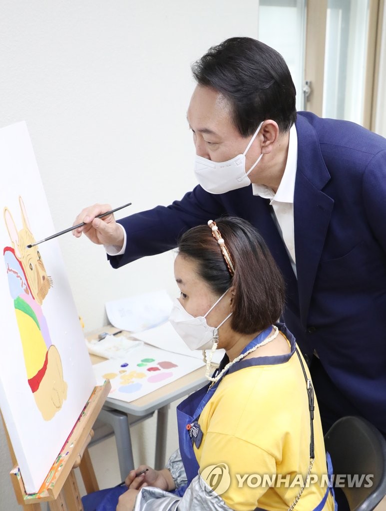 Yoon visits facility for people with developmental disorders
