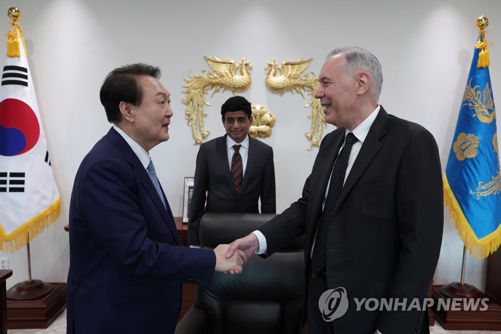 握手する尹大統領（左）とディッカーソン氏（大統領室提供）＝（聯合ニュース）≪転載・転用禁止≫