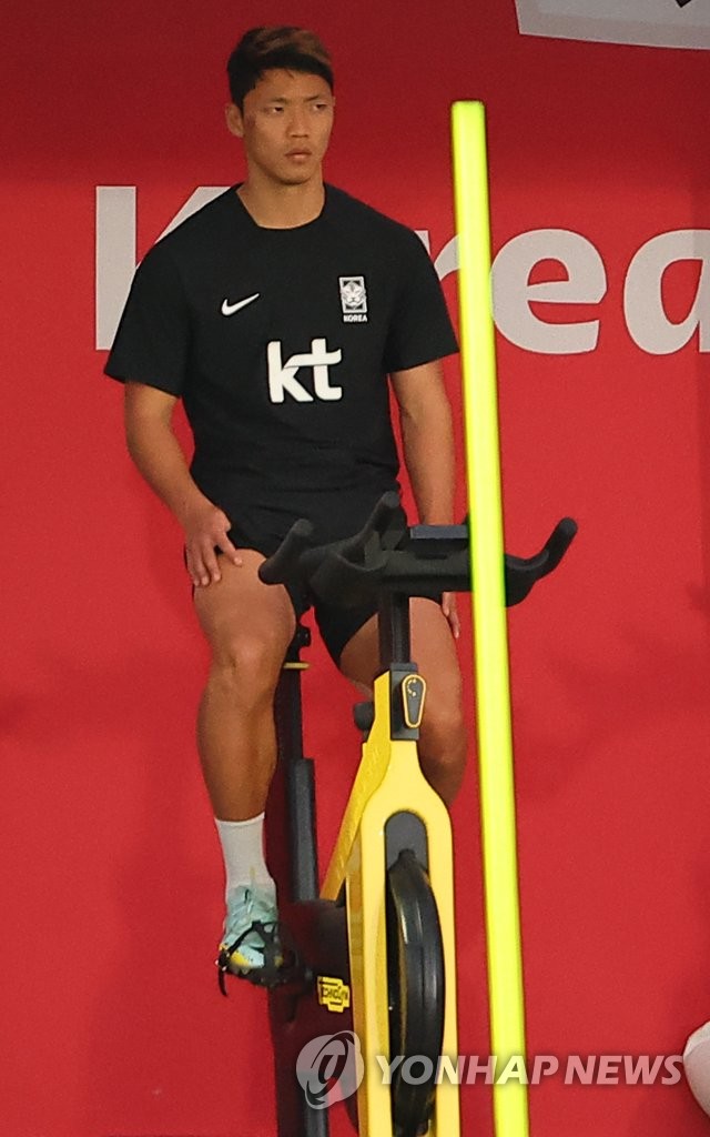 Hwang Hee-chan of South Korea rides a stationary bicycle while preparing for the FIFA World Cup at Al Egla Training Site in Doha on Nov. 22, 2022. (Yonhap)
