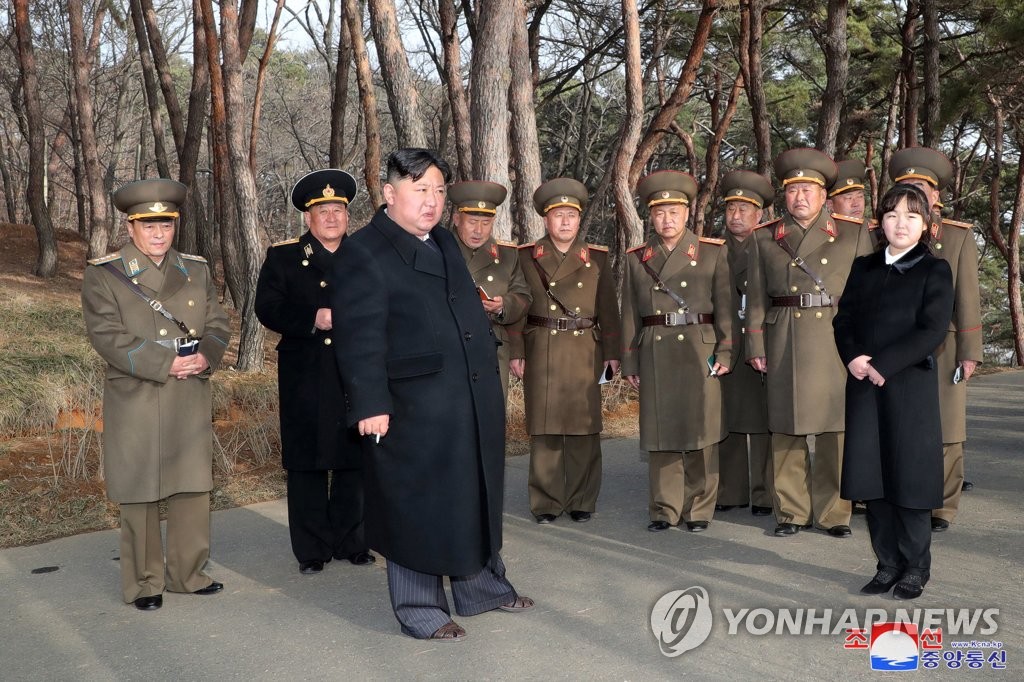 El líder norcoreano Kim Jong-un (C, al frente), junto a su hija Ju-ae (R), inspecciona un "simulacro de asalto de fuego" de la unidad de artillería Hwasong del Ejército Popular de Corea en la ciudad portuaria de Nampho, en el oeste de Corea del Norte, el 9 de marzo de 2023, en esta foto publicada por la Agencia Central de Noticias oficial de Corea del Norte.  Durante el simulacro, Kim enfatizó la necesidad de "responde abrumadoramente" a los preparativos de guerra del enemigo.  (Para uso exclusivo en la República de Corea. Sin redistribución) (Yonhap)