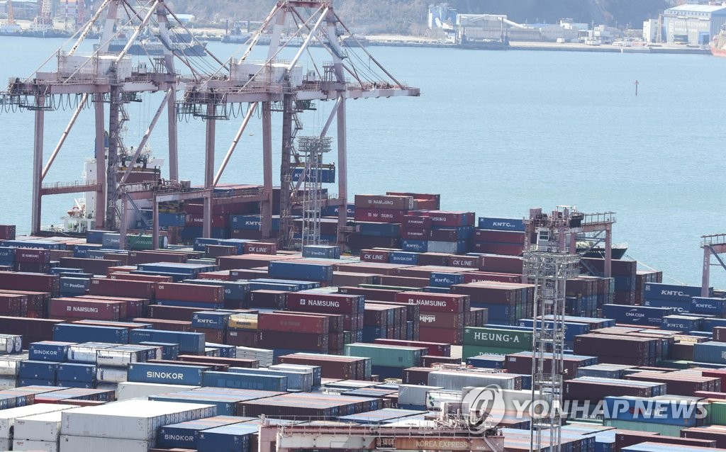 Containers are piled up at a port in the southeastern port city of Busan on March 13, 2023. (Yonhap)