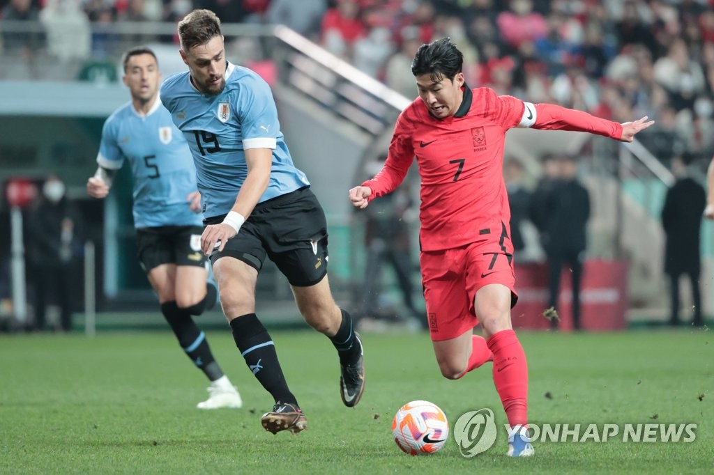In this file photo from March 28, 2023, Son Heung-min of South Korea (R) tries to dribble past Federico Valverde of Uruguay during a men's football friendly match at Seoul World Cup Stadium in Seoul. (Yonhap)