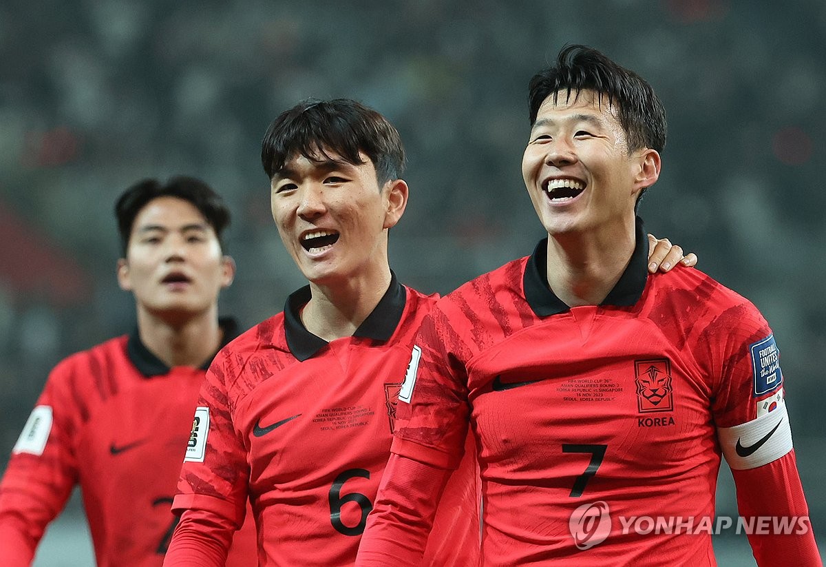 Son Heung-min of South Korea (R) smiles next to teammate Hwang In-beom (C) after scoring against Singapore during the teams' Group C match in the second round of the Asian World Cup qualification tournament at Seoul World Cup Stadium in Seoul on Nov. 16, 2023. (Yonhap)